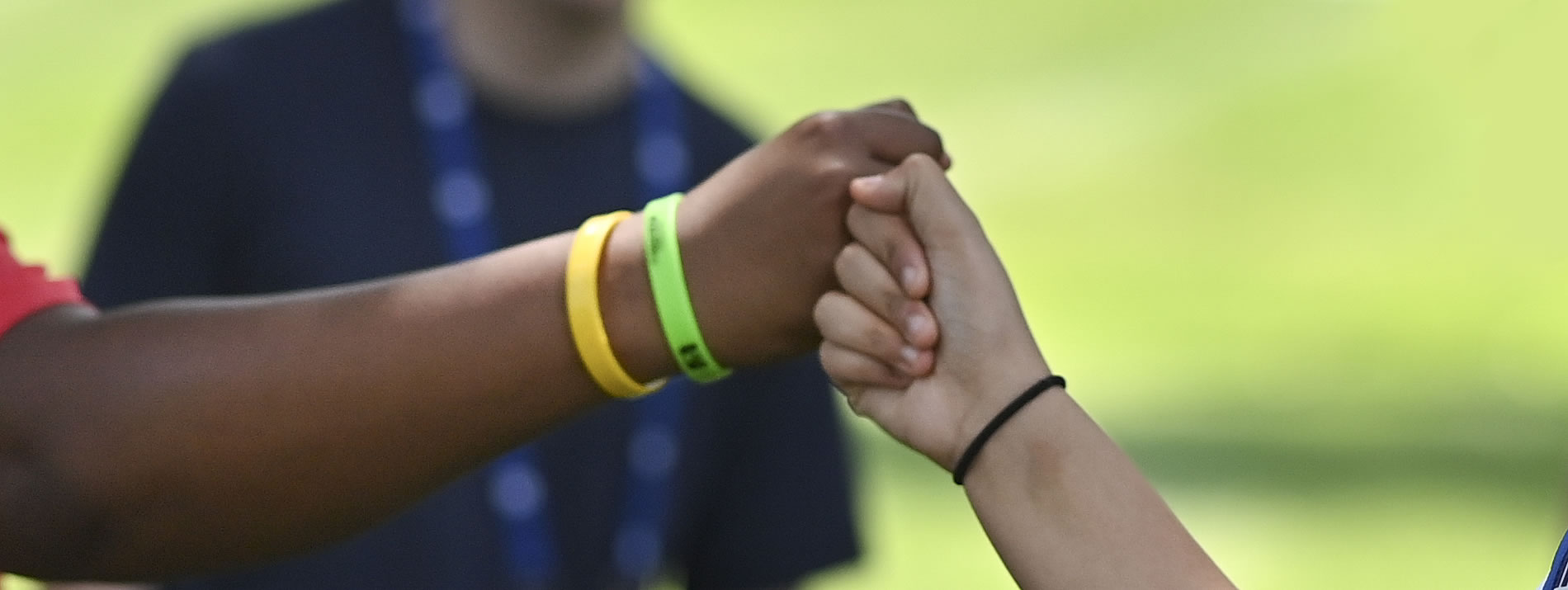 two students of color fist bumping