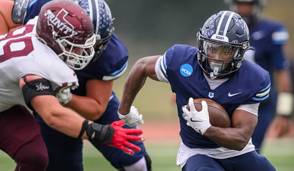 Berry football player runs with ball
