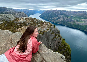 girl overlooking a cliff with a river below