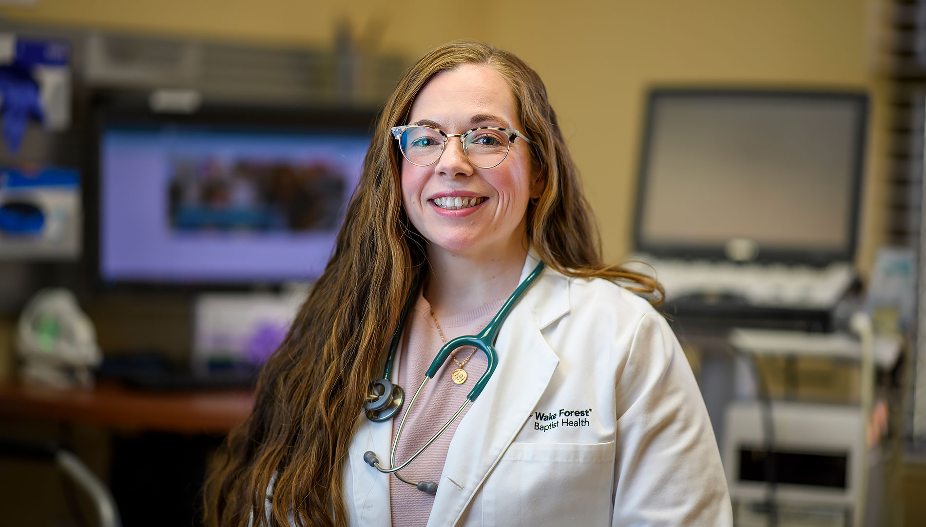 Dr. Katie Edenfield Price standing in exam room.