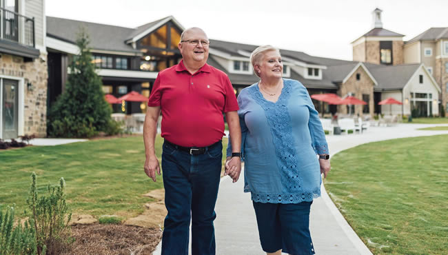 Sam and Nancy Duval Ratcliffe walking together while holding hands