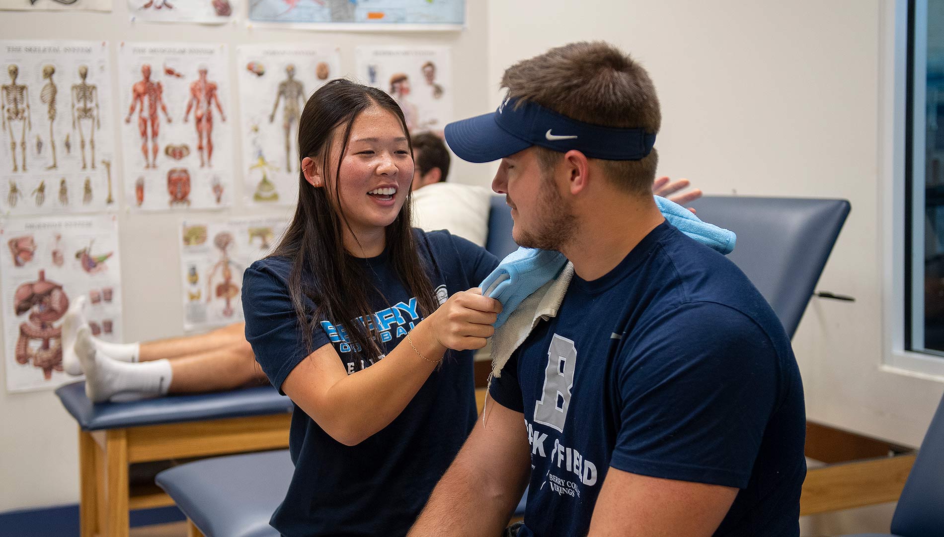Student athletic trainer Jamie Jang works with an athlete.