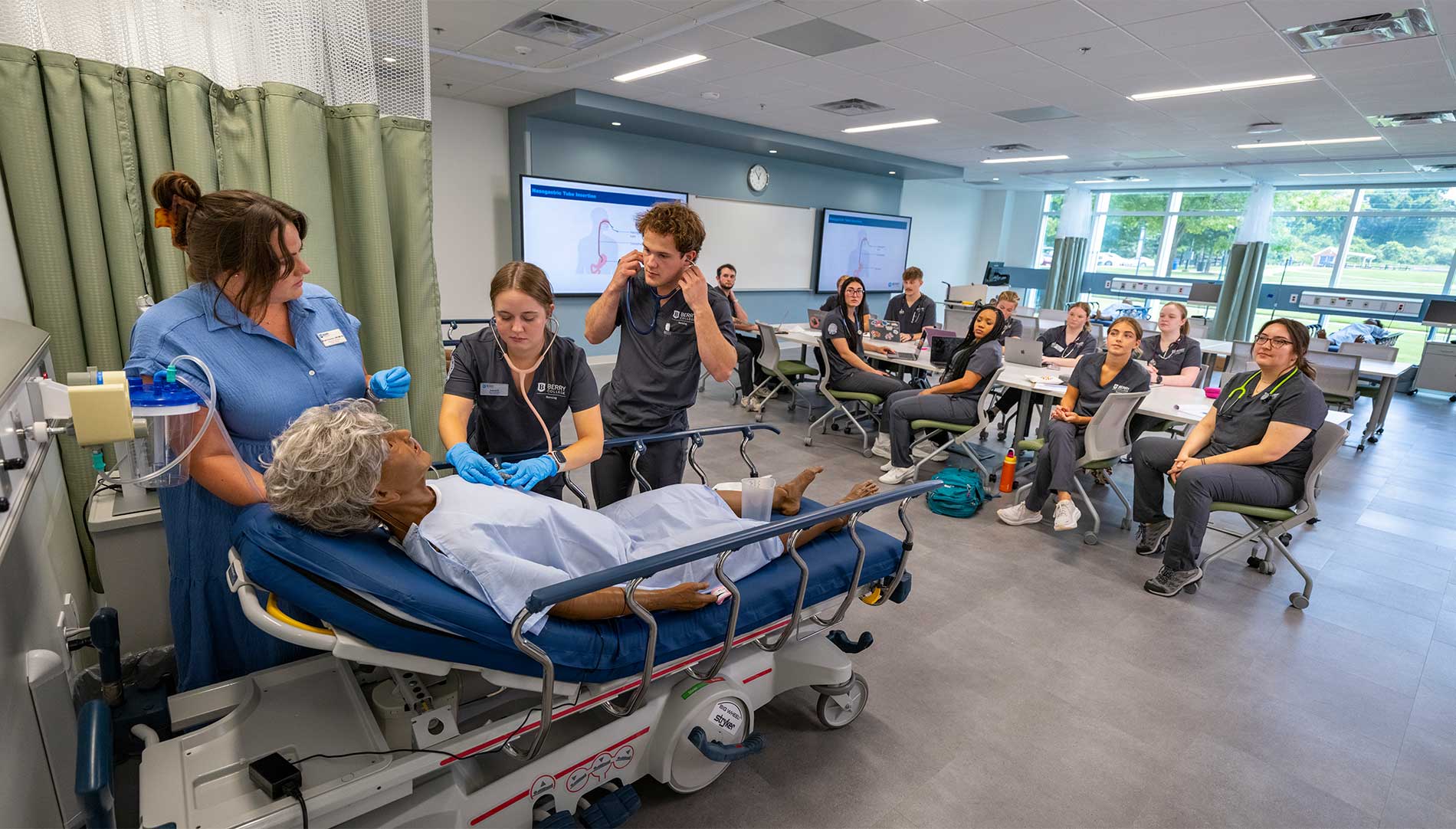 Class of nurses observing a live patient care simulation