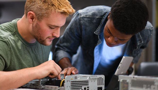 two students working on a computer
