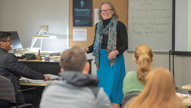 Mary C. Clement lecturing in front of a classroom
