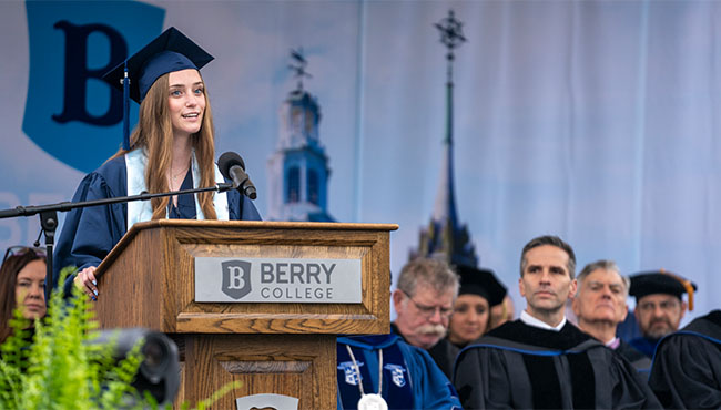 Graduating senior Sydney Summers addresses the crowd at a podium