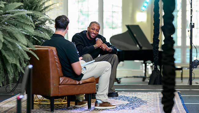 Two people conducting an interview on stage