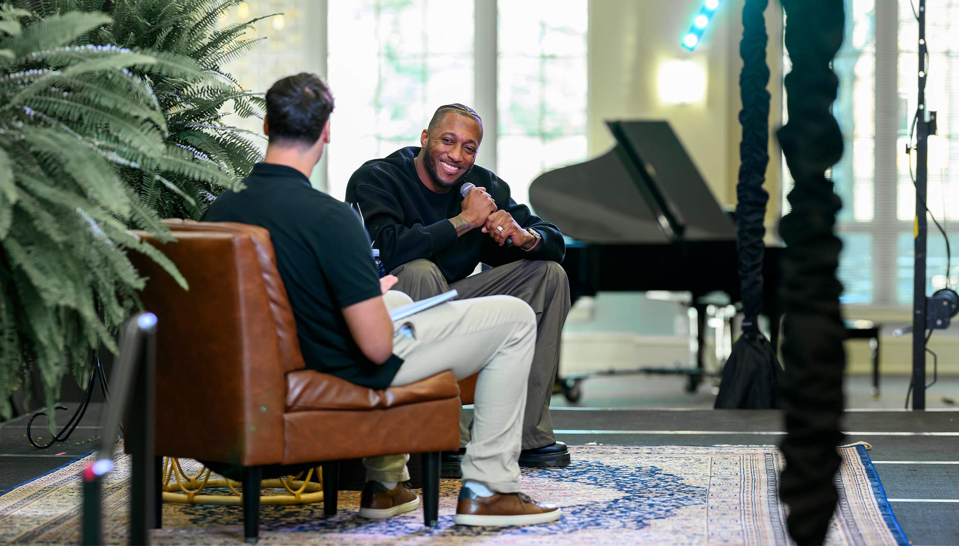 Two people conducting an interview on stage