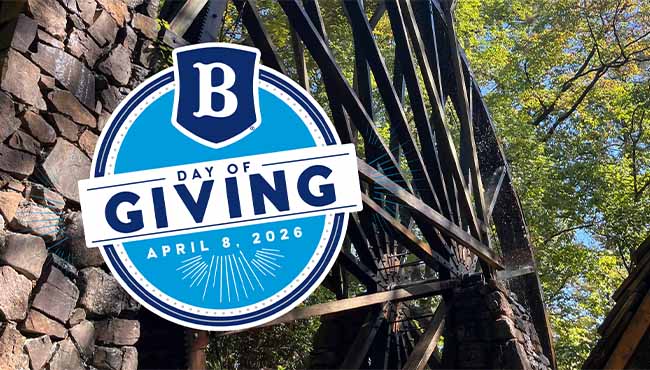 Berry College Faculty and Staff standing together on a staircase wearing matching shirts