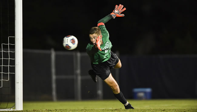 Carson Oakes catches a soccer ball