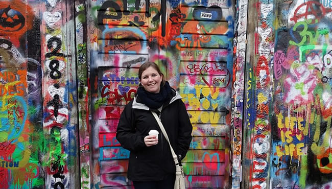 Kip Webster in front of graffiti wall