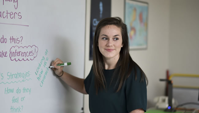 Megan Radosta writing on a white board