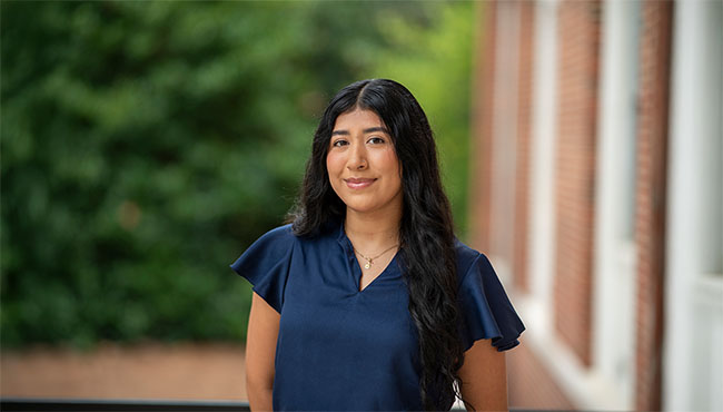 Ashley Castaneda smiling outside Hermann Hall on Berry campus
