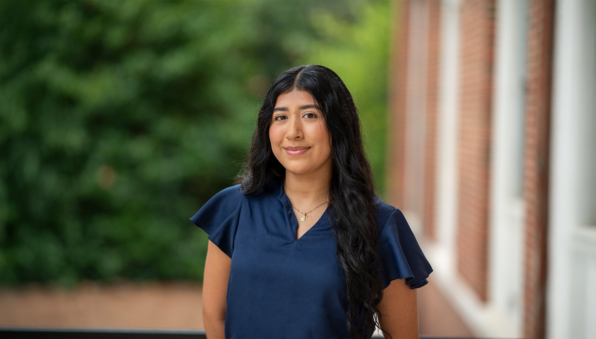 Ashley Castaneda smiling outside Hermann Hall on Berry campus