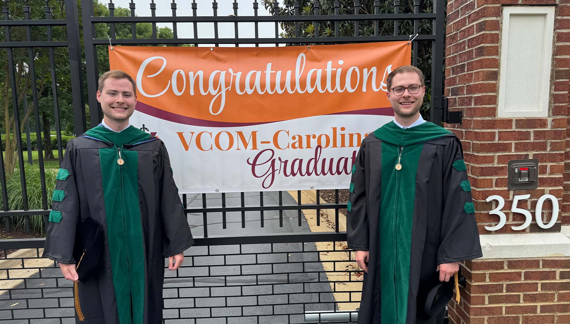 Ethan and Grant Calhoun smiling in graduation robes