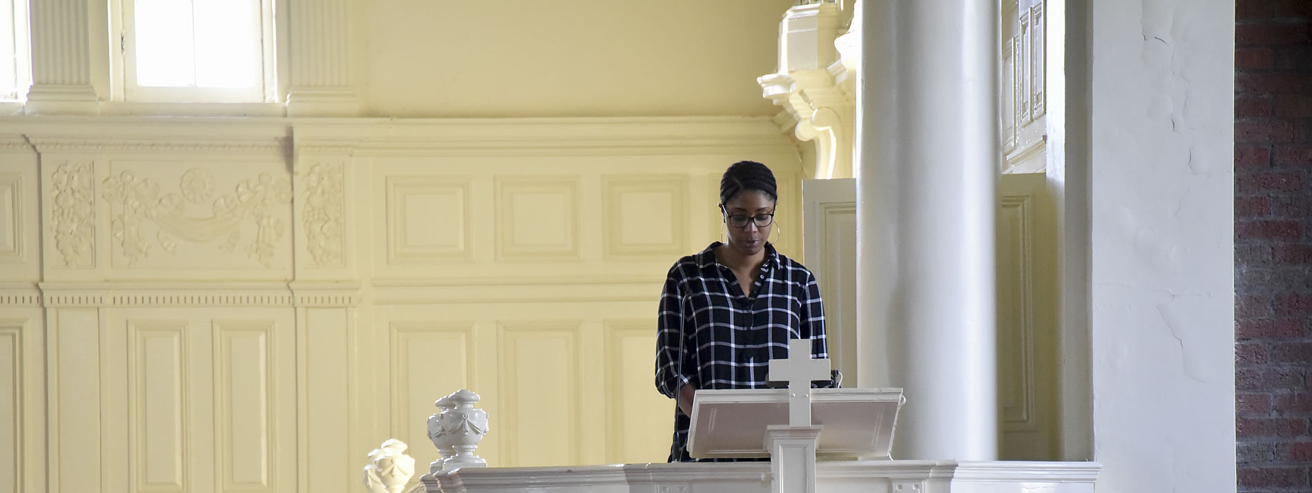 Woman reading at a pulpit
