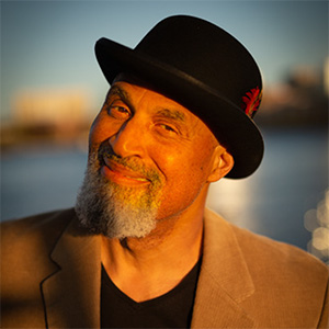 Tim Seible in a hat, grinning.