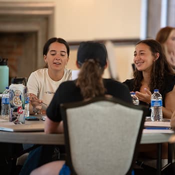 Students talking at a table