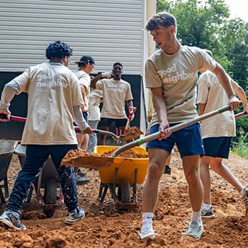 Students using shovels during service